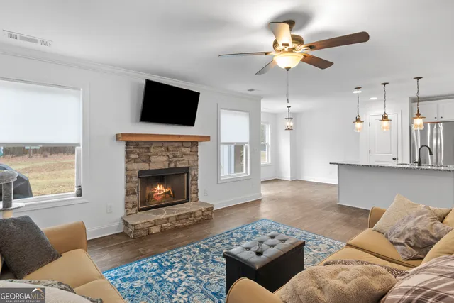 a living room with furniture a fireplace and a flat screen tv