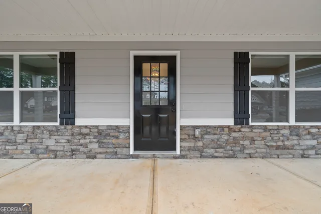 front view of a brick house with glass door