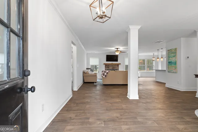 a view of living room kitchen with furniture and wooden floor