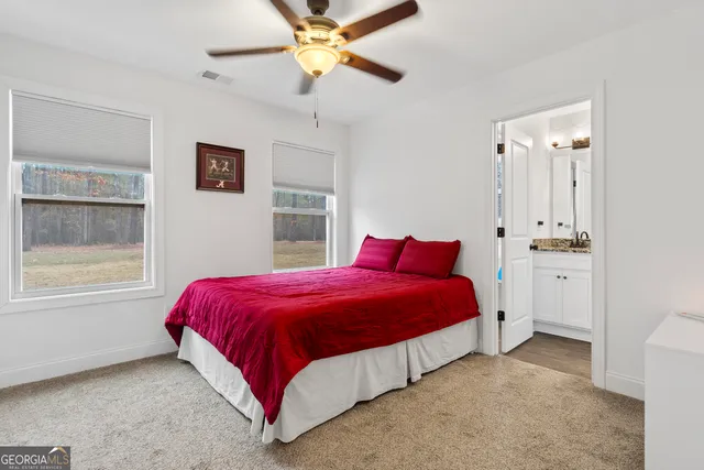 a spacious bedroom with a bed and a window