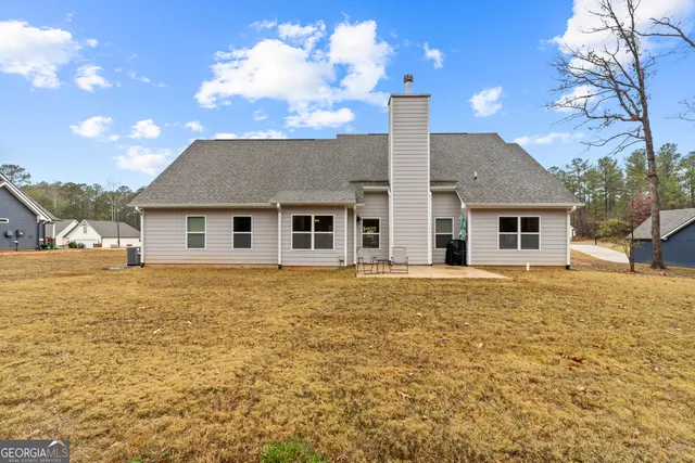 a swimming pool with outdoor seating and trees