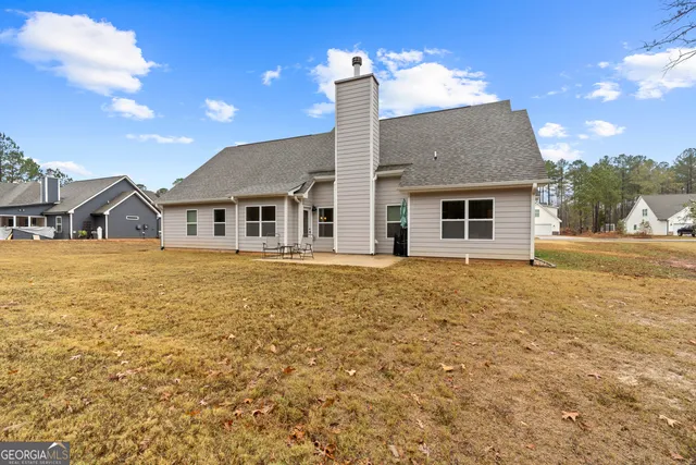 a swimming pool with outdoor seating and trees