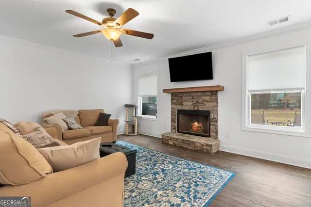 a living room with furniture a flat screen tv and a fireplace