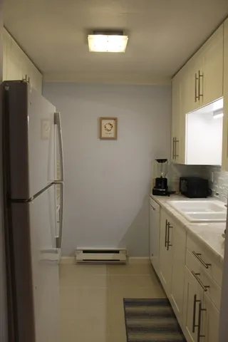 a kitchen with a refrigerator and a sink