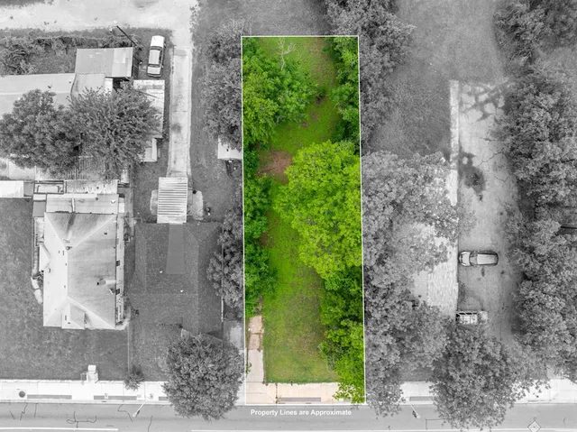 a aerial view of a brick house with a yard