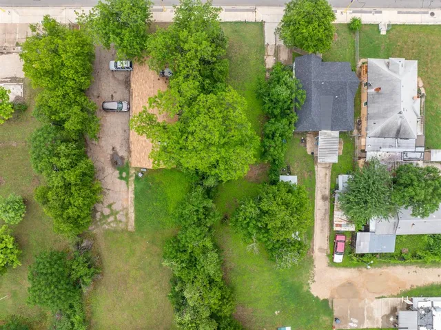 an aerial view of a house with a yard and lake view