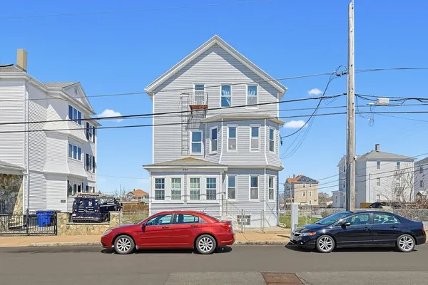 a view of a house with a balcony and furniture