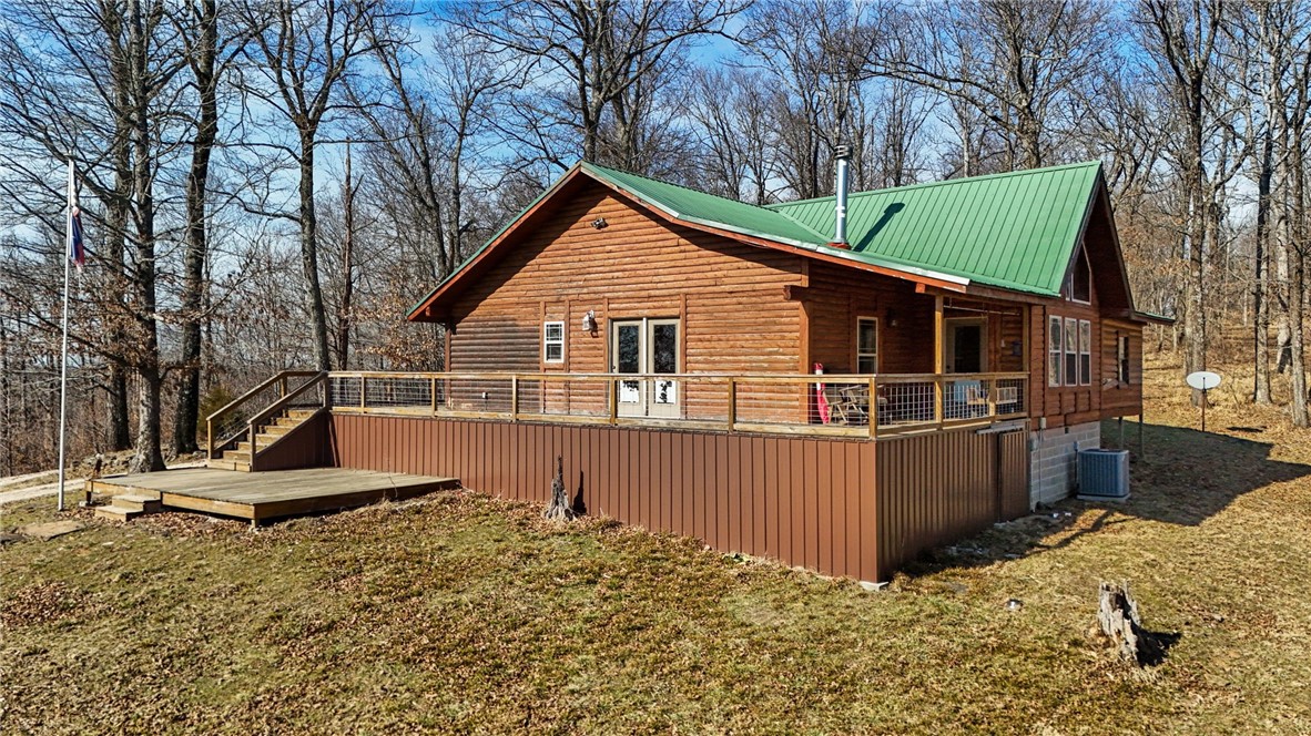 10557 North Devils Den Road Winslow, AR 72959 - Photo 40 of 60 View of side of home featuring a deck, a lawn, and a metal roof