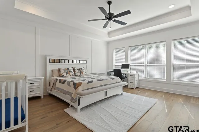 a view of a bedroom with furniture and windows
