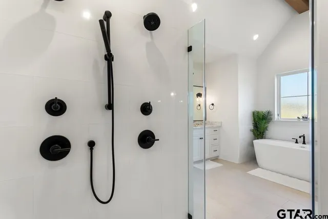 a bathroom with a shower and tub