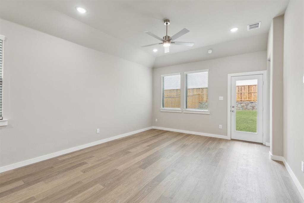 8308 Coastal Lane Pilot Point, TX 76258 - Photo 15 of 32 wooden floor in an empty room with a window