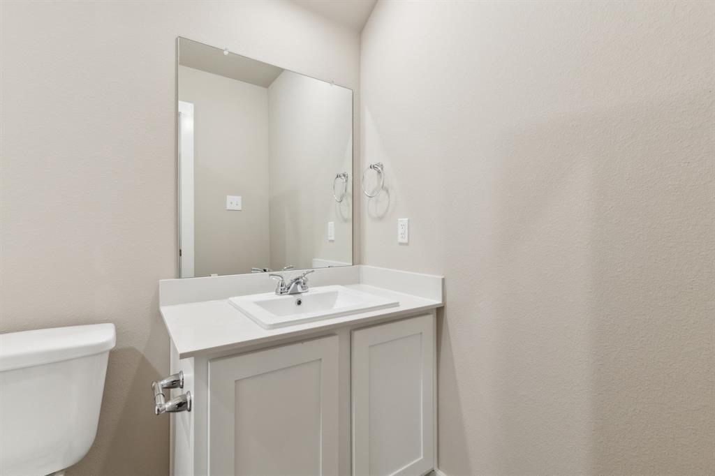 8308 Coastal Lane Pilot Point, TX 76258 - Photo 25 of 32 a bathroom with a sink and a toilet
