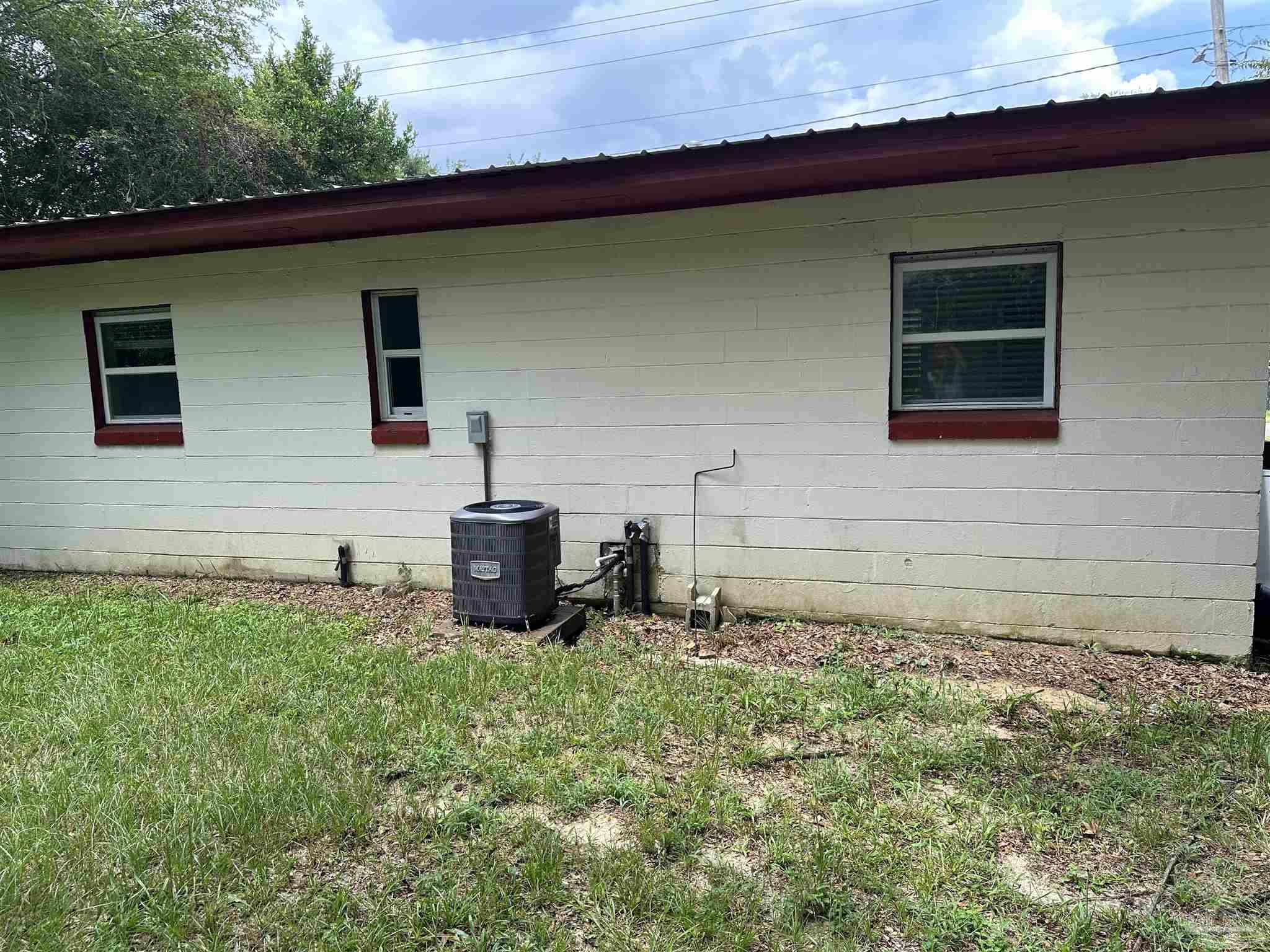 425 Well Line Road Cantonment, FL 32533 - Photo 11 of 13 a backyard of a house with table and chairs