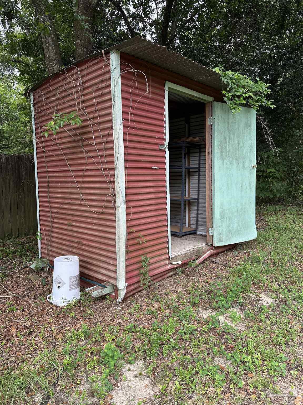 425 Well Line Road Cantonment, FL 32533 - Photo 13 of 13 a front view of a house with a yard