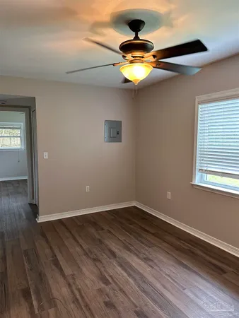 wooden floor in an empty room with a window