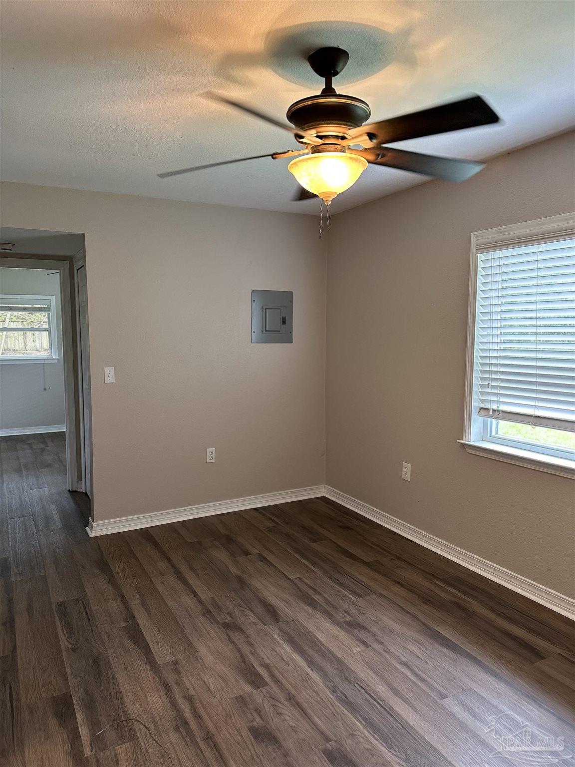 425 Well Line Road Cantonment, FL 32533 - Photo 5 of 13 wooden floor in an empty room with a window