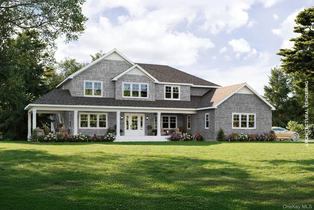 a front view of a house with a garden and trees