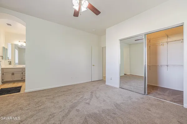 an empty room with fireplace and windows