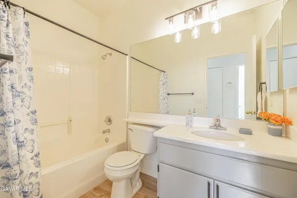 a view of empty room with wooden floor and fireplace