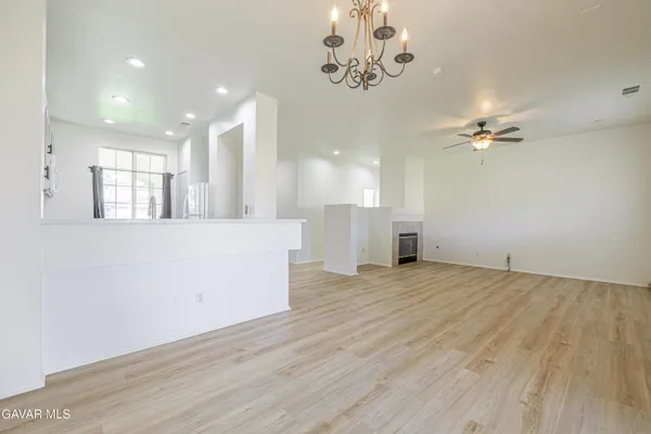 a view of a spacious bedroom with wooden floor