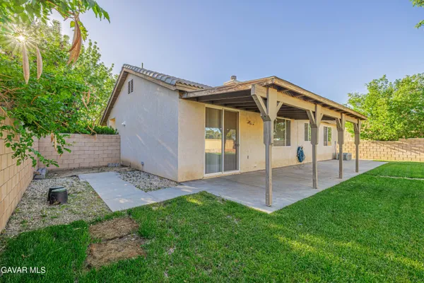 a view of a house with a yard and deck