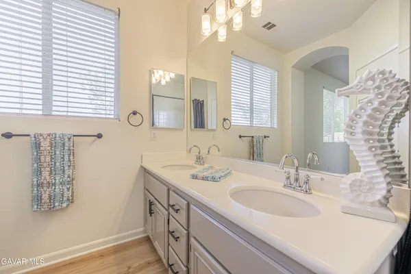 a bathroom with a sink double vanity and a mirror