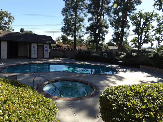 a view of a house with a potted plant ana a small yard