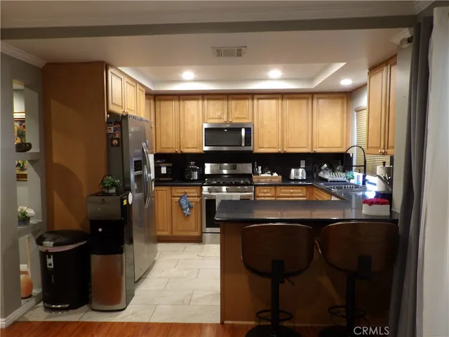 a kitchen with a sink appliances and cabinets