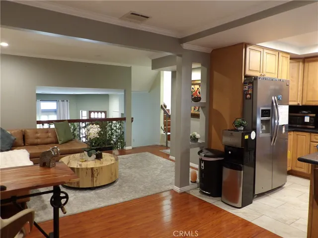 a living room with a black white checkered table with a gaming machine and dining table