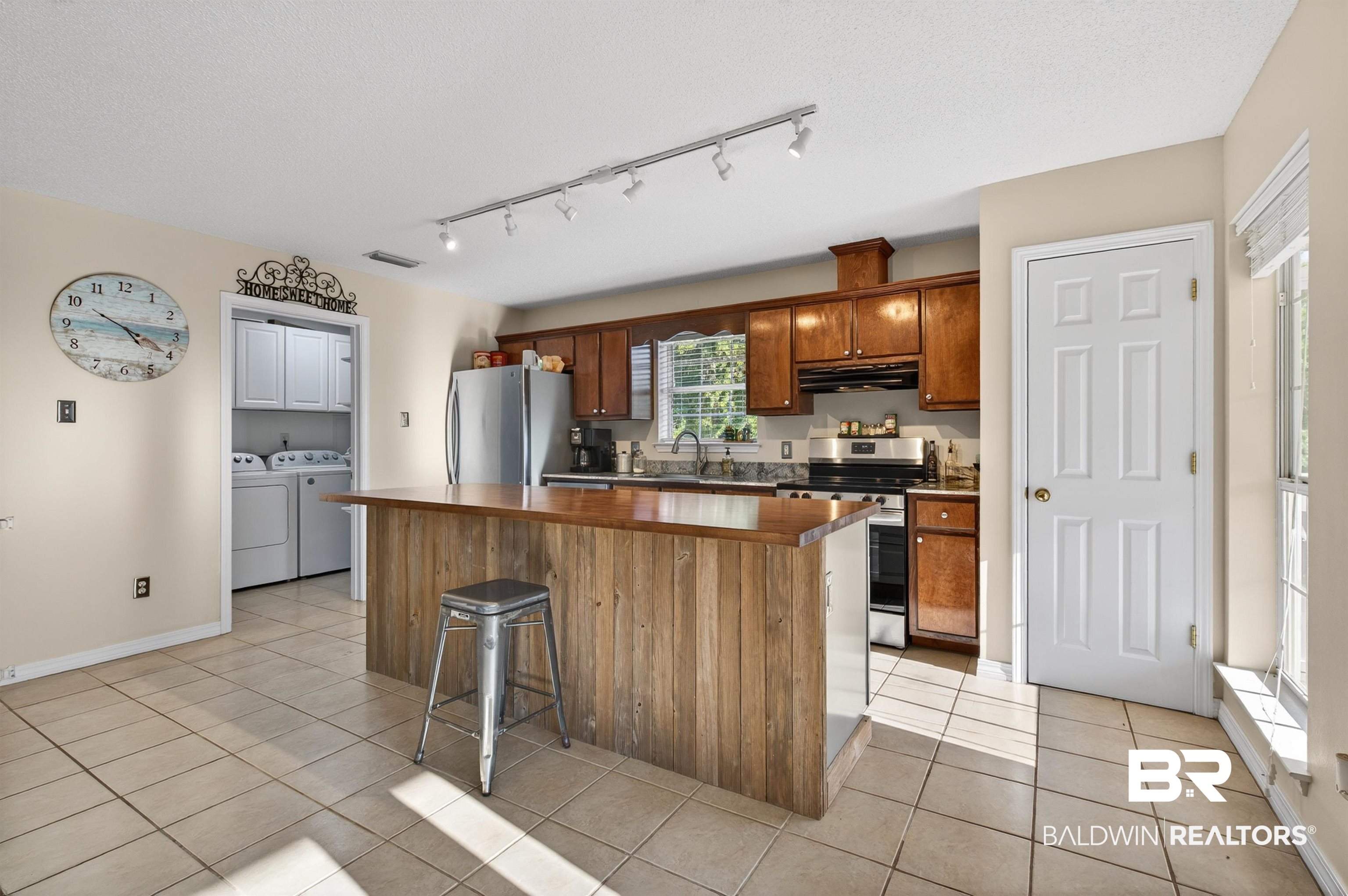 9624 North Bay Street Foley, AL 36535 - Photo 10 of 59 Kitchen featuring a wood-finish island, track lighting, and tile flooring