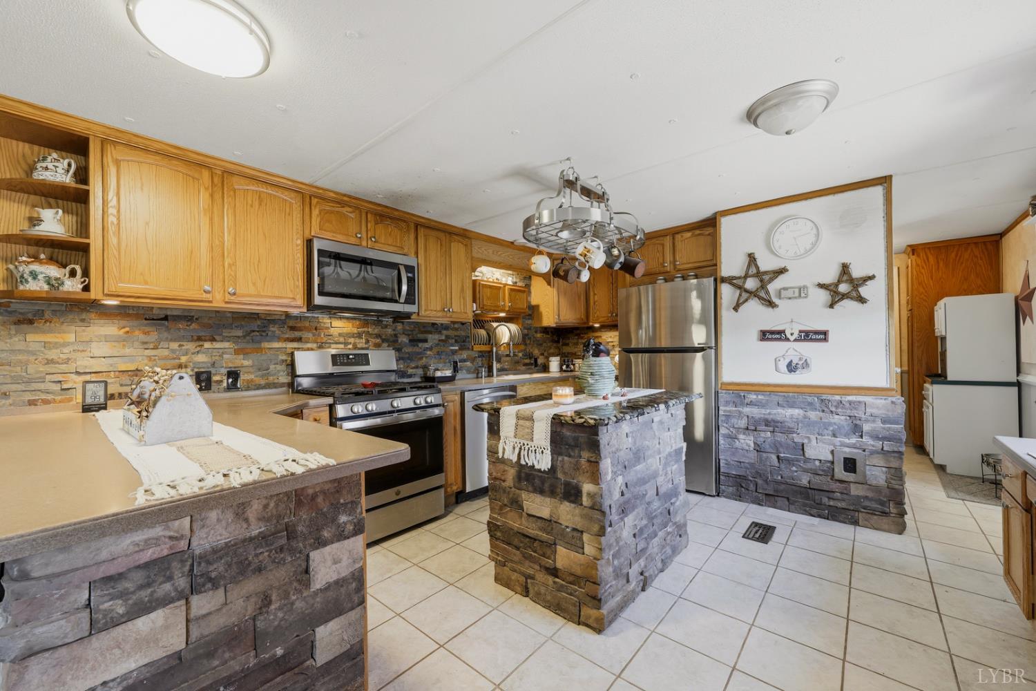 809 Plantation Road Amherst, VA 24521 - Photo 20 of 77 a kitchen with stainless steel appliances granite countertop a stove top oven a sink a counter space and cabinets