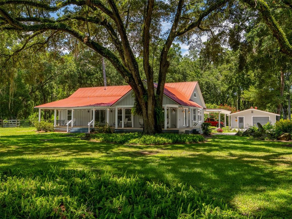 a backyard of a house with table and chairs