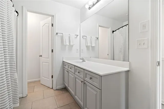 a bathroom with a double vanity sink and a mirror