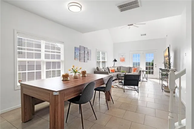 a view of a dining room with furniture and a potted plant