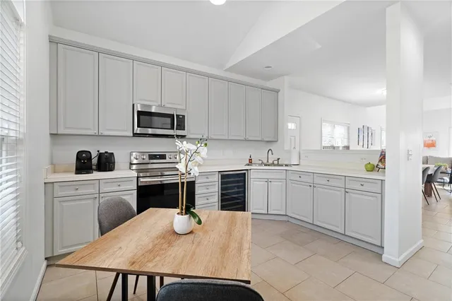a kitchen with cabinets appliances a sink and a counter top space