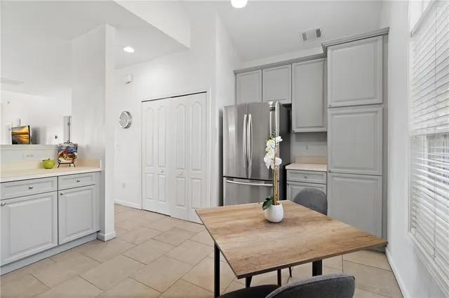 a kitchen with refrigerator cabinets and wooden floor