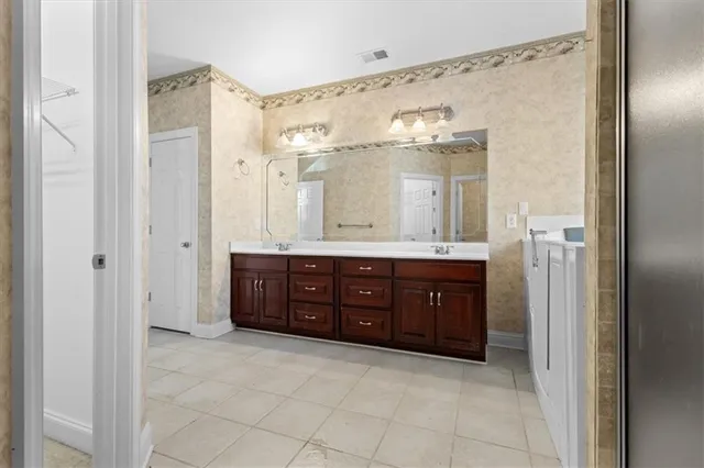 a bathroom with a granite countertop sink mirror and shower