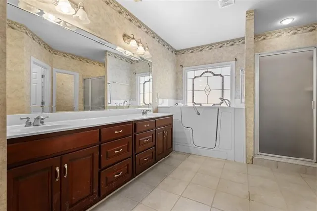 a spacious bathroom with a granite countertop sink mirror and a