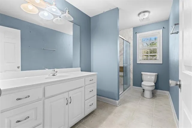 a bathroom with a double vanity sink mirror and toilet