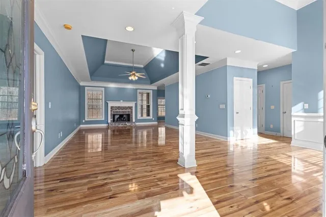 a view of dining room with wooden floor and a fireplace