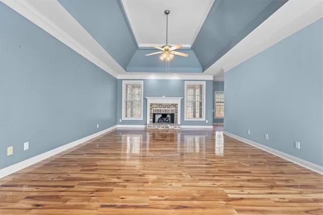 a view of livingroom with fireplace chandelier fan and window