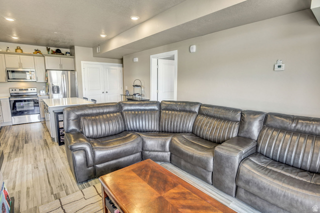 2101 North Main Street, Unit 306 Sunset, UT 84015 - Photo 9 of 22 Open-concept living area featuring wood-finish flooring and recessed lighting