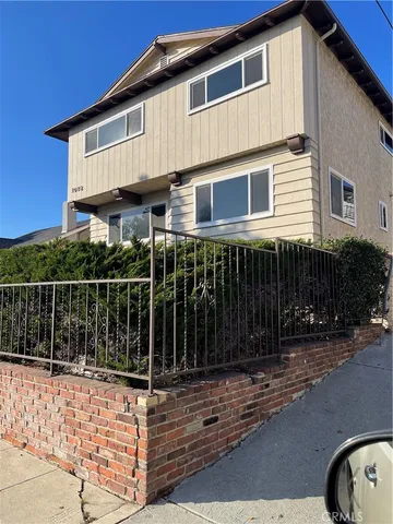 a front view of a house with iron fence