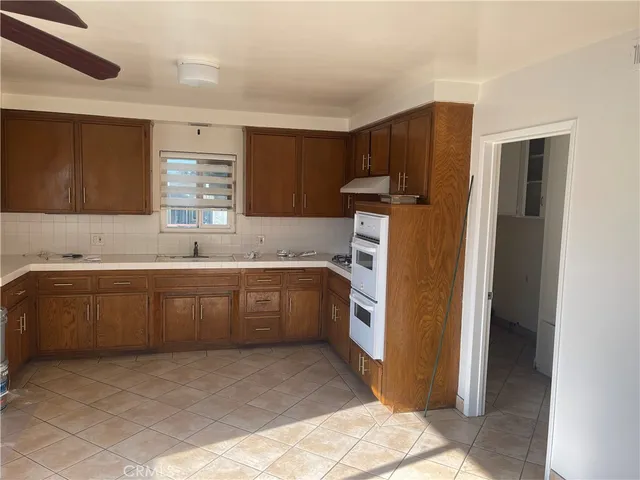 a kitchen with a refrigerator sink and cabinets