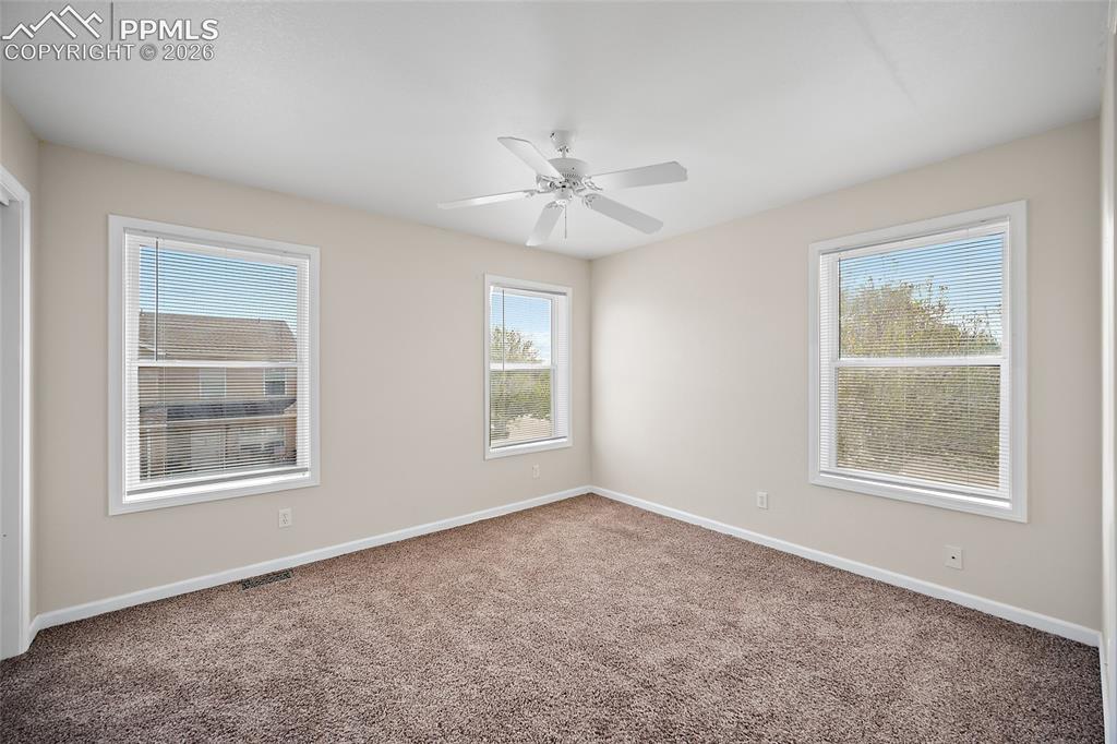 4400 Rawhide Road, Unit 157 Pueblo, CO 81008 - Photo 21 of 36 an empty room with windows and ceiling fan