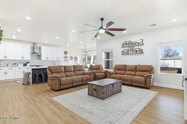 a living room with furniture and kitchen view