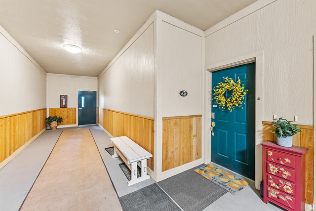 900 Bitner Road, Unit K25 Park City, UT 84098 - Photo 22 of 35 Entryway featuring wood paneling, light wall finishes, and a flush-mount ceiling light