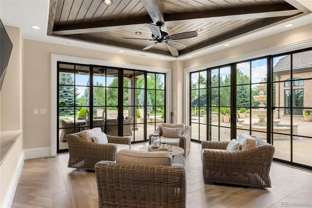a living room with furniture and a floor to ceiling window
