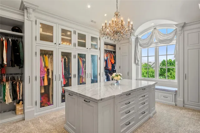 a view of a hallway with a window and chandelier