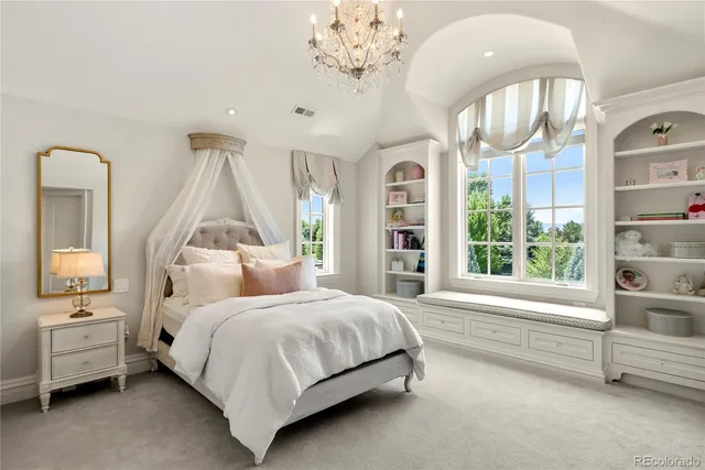 a bedroom with a bed and a large window
